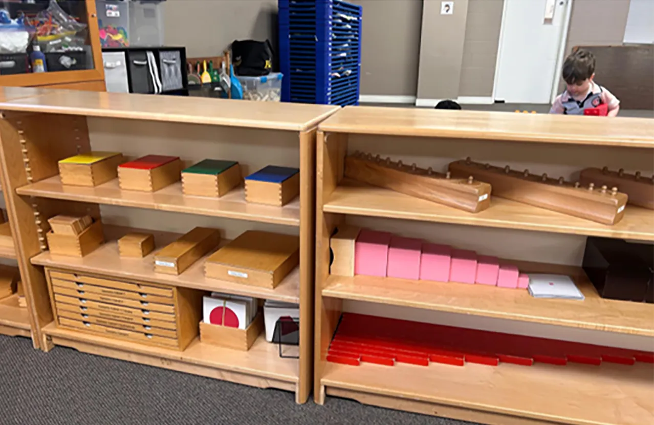 Montessori learning materials arranged on classroom shelves