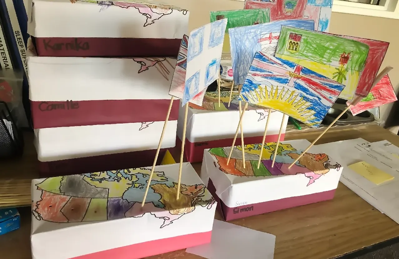 Children's maps and flags created during a classroom activity